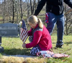 Youth football league lays flags at graves of fallen soldiers